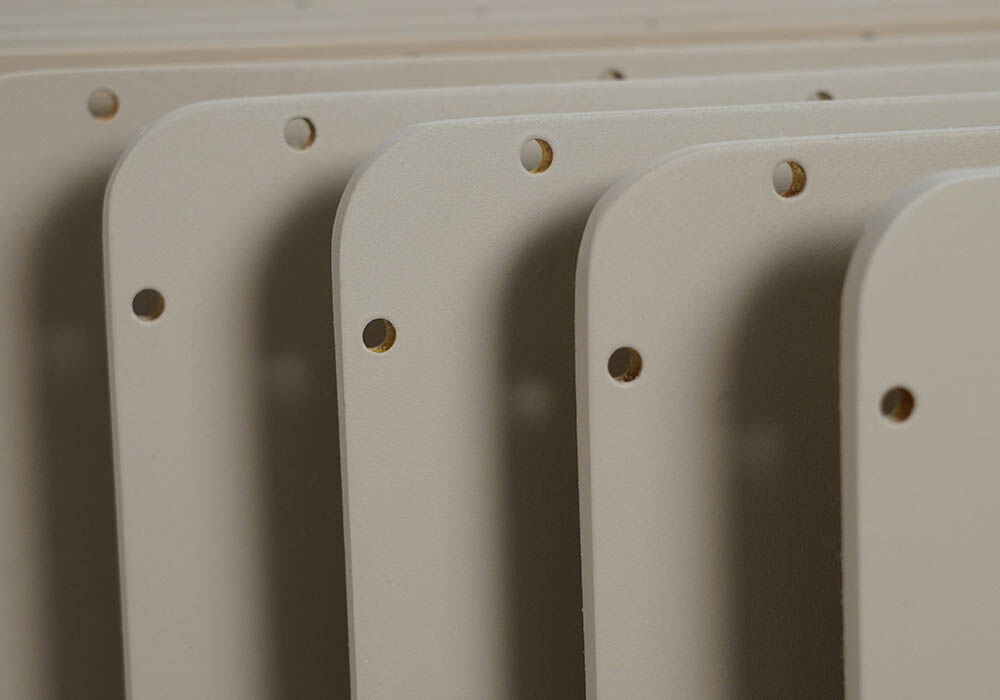 Detail photograph of the corner of the radome covers that highlights the machining and painting along each edge. 