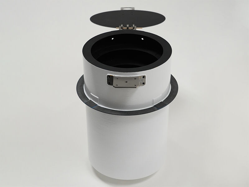 Image shows a white cylindrical sunshade structure with an open black lid on a white background. The black is carbon fiber, and the white is painted. There are metallic hinge structures for the lid.