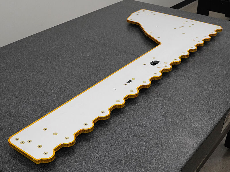 Spacecraft bus, shaped radiator panel with embedded heat pipes