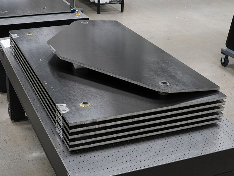 Stack of carbon fiber panels with precision inserts that make up a solar wing.  Corner isotropic view. 